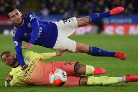 Manchester City's Kyle Walker and Leicester City's Ben Chilwell vying for the ball during an English Premier League match.