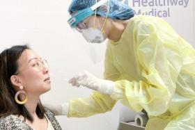 A patient at Healthway Medical&#039;s Downtown Gallery clinic getting swabbed for Covid-19. People who need a Covid-19 PCR test will be able to request one from approved private clinics from Dec 1, 2020.