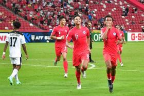 Singapore&#039;s Shakir Hamzah (right) celebrates after scoring in the 2-0 win over Timor-Leste.