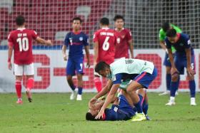 Singapore&#039;s Faris Ramli, who missed a penalty in the dying minutes of regulation time, lying down inconsolable after Indonesia beat Singapore during the AFF Suzuki Cup semi-finals on Dec 25, 2021. 