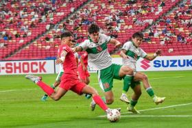 Singapore&#039;s Ikhsan Fandi (in red) in action during the AFF Suzuki Cup 2020 semi-final first leg match against Indonesia on Dec 22, 2021.