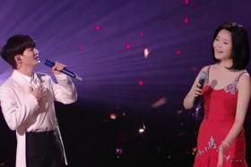 Chinese singer Zhou Shen (left) with a hologram of late singer Teresa Teng at Jiangsu Television's New Year Countdown Concert.