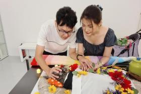 Mr Shaun Koh (left) and Dr Donna Chow share a final moment with their deceased miniature schnauzer, Ah Bee.