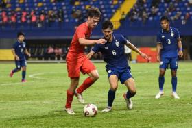 Singapore's Ryhan Stewart (left) in action with Thailand's Sittha Boonlha during the U23 AFF Championship opener, on Feb 16, 2022. 