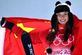 Gold medallist China's Eileen Gu poses on the podium during the venue ceremony after the freestyle skiing women's freeski halfpipe final run during the Beijing 2022 Winter Olympic Games at the Genting Snow Park H & S Stadium in Zhangjiakou on Feb 18, 2022. 