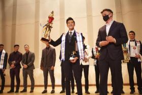 Manhunt Singapore 2021 winner Hong Yu Chao posing with his trophy. Mr Hong was born with a hole in his heart. 