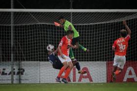 Hougang goalie Mukundan Maran makes a save during the Singapore Premier League match against Tanjong Pagar. 
