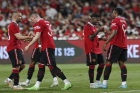 Manchester United&#039;s Fred (17) celebrates with teammates after scoring their second goal against Liverpool. 
