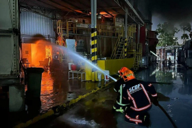 SCDF firefighters are fighting the fire with six water jets and an unmanned firefighting machine. PHOTO: SCDF/FACEBOOK
