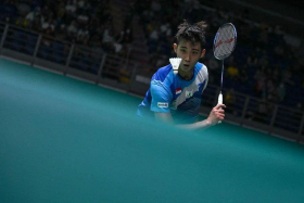 Singapore&#039;s Loh Kean Yew loses 21-16, 16-21, 21-7 to China’s world No. 13 Zhao Junpeng in the opening round of the All England Open men’s singles event. PHOTO: AFP
