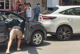 The man in black was spotted looking for something in a black car, while the man in white appeared to be accompanied by a woman carrying a young child.