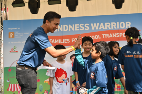 North East CDC vice-chairman Elmie Nekmat presenting a beneficiary with a prize after the Kindness Warrior 2024 Relay.