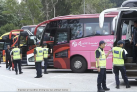 Malaysia's enforcement officers inspecting tour buses and vans in Gombak, Selangor, on July 2. 
