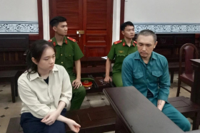 Shawn Han Sxe Siang and his partner Loh Si Yu at the Ho Chi Minh City People's Court.