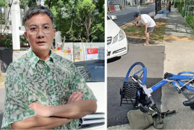 The cyclist left his bike on the road and left after he rode into Chen Hanwei's (left) car.