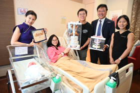 Baby Eva Faith Koh and her mum Ng Cai Yu with (from left) KKH medical board chairman Chan Yoke Hwee, Eva's dad John Koh, KKH CEO Alex Sia and KKH associate consultant Stella Rizalina Sasha Sugianto.