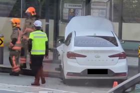 The car crashed into a central divider railing before hitting a concrete bollard at a bus stop in front of the Metta School.