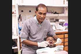 Dr Simon Mahendran pays it forward with affordable dental services for migrant workers.