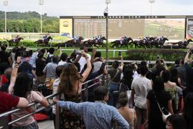 Racegoers capturing a slice of history as the $1.38 million Group 1 Grand Singapore Gold Cup (2,000m), the final race to be run in the Republic, gets under way at Kranji Racecourse on Oct 5. 