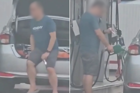 The man used a torch to check his fuel tank.