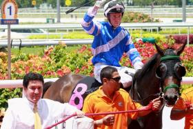 Theo Kieser (left) leading in the first of his 165 Singapore winners, Win Lots (Ronnie Stewart) on May 2, 2010.