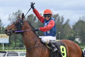 Jerlyn Seow waving to the crowd as she brings Witnessimpact back to scale after their stellar win in the Supreme A race (1,200m) at Sungai Besi on Jan 12.
