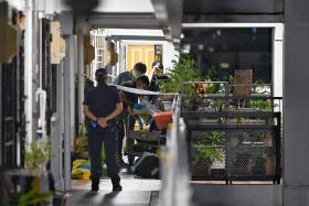 The forensic investigation team is seen at the crime scene on the 11th floor.