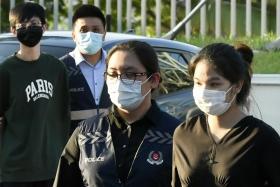 Pansuk Siriwipa (right) being escorted by the Singapore police at Woodlands Checkpoint on Aug 11, 2022.