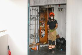 An SCDF firefighter at a flat in Block 971 Hougang Street 91 on Jan 10, a day after a fire broke out at the unit.