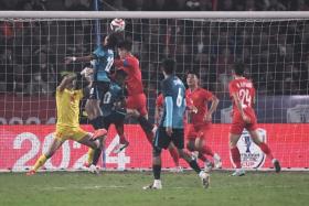 Singapore's Faris Ramli heading in a goal against Vietnam which was later disallowed.