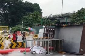 In a video posted by SG Road Vigilante, a white lorry can be seen lying on its side, with several cylinders emitting white smoke.
