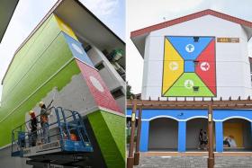 Workers repainting the wall of Block 479 Tampines Street 44 (left) on July 5. It is one of 13 blocks painted in June with nostalgia-themed motifs, such as aeroplane chess.