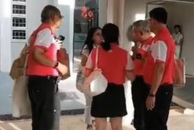 One of the videos released by Mr Azman Ibrahim shows a group of PSP members standing in a circle speaking to an unidentified female PAP volunteer.