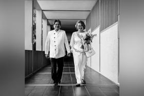 Ms Sylvia Lim posted a black and white picture of her and Quah Kim Song walking hand in hand down a corridor at the St Mary of the Angels church.