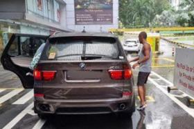 The driver of the BMW X5 allegedly shoved the security officer to the ground, causing the man to fracture his palm and injure his lower back.