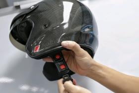 A helmet with a quick-release mechanism. Updated testing standards will allow motorcycle helmets with such a mechanism to be approved in Singapore.