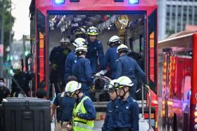 Casualties being transferred to a mass decontamination vehicle outside One Raffles Quay.