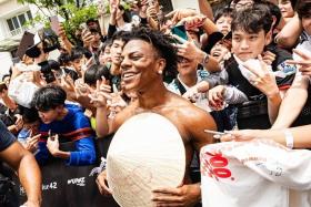 Speed takes photos with his fans at the Gumball 3000 event in Vietnam.