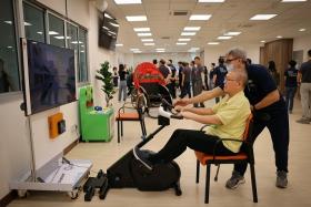 Mr. Hoong Yan Pui (seated) at the REACH-SLEC Active Ageing Centre (Care) @ Teck Whye Vista on the day of its official opening on Oct 11.