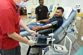 Migrant workers Sahad Mohammad (centre) and Saeid Mohammad Abu (right) at Bloodbank@HSA.