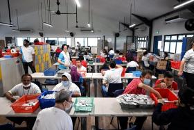 Clients at an activity workspace called Oaktree, which supports ageing clients who are 45 and above, at Minds Regional Hub (Hougang).