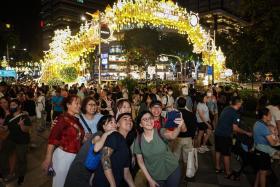 People taking photo after the Christmas On A Great Street Community Chest Light-Up Ceremony at Orchard Road on Nov 9. 