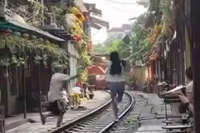 A video posted on Facebook showed a woman coming out onto the track and seemingly pose for a photo as the train approached.