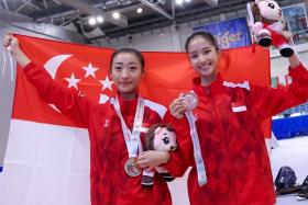 Singapore's Vera Tan (right) and Zeanne Law clinched golds in the World Taijiquan Championships women's optional taijijian and taijiquan respectively.